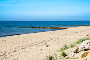 baltic sea beach with wooden breakwaterr