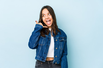 Young mixed race hispanic woman isolated showing a mobile phone call gesture with fingers.