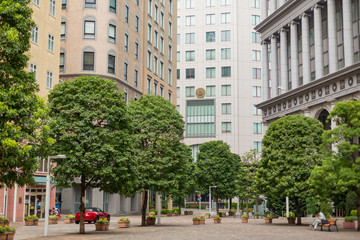 public park and buildings of italian street in tokyo, japan