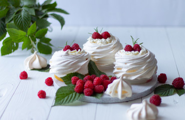 Pavlova meringue cakes with fresh raspberries