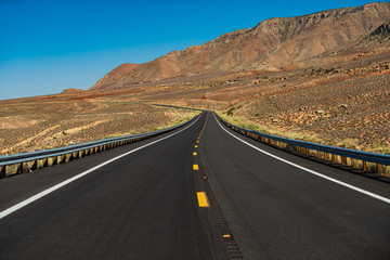 Asphalt texture, way background. Mohave desert by Route 66 in California Yucca Valley USA. American roadtrip.