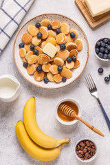 Trendy breakfast with mini pancakes and blueberries.