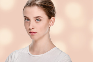 Portrait of young serious girl with perfect smooth skin