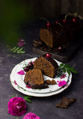 homemade chocolate cupcake with cherries on a dark background