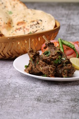Mutton curry Served with naan or bread  over wooden background.