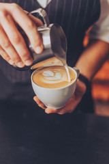 Barista making an ornament for cappuccino 