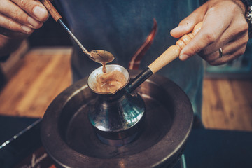 Fototapeta na wymiar Boiling Turkish coffee in a copper kettle