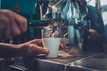 Barista making an espresso on the espresso machine 
