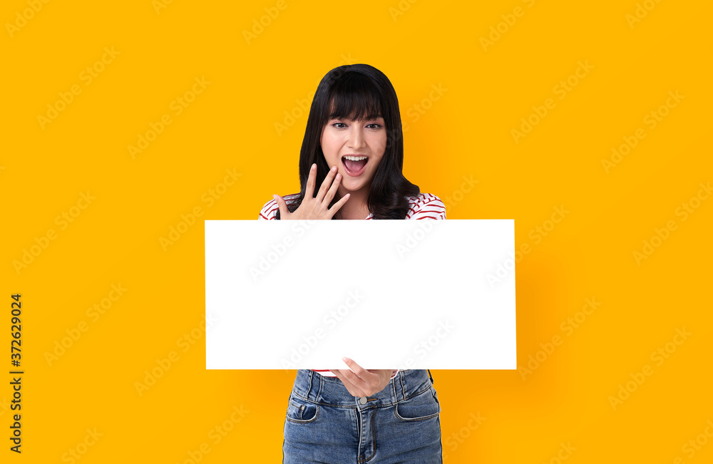 Wall mural excited young asian woman with empty speech bubble studio shot on yellow background.