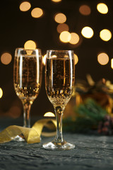 selective focus of glasses full of champagne against christmas lights