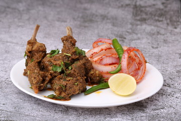 Bhuna Gosht Mutton masala OR Indian Lamb Curry with onion Served in a plate over moody background