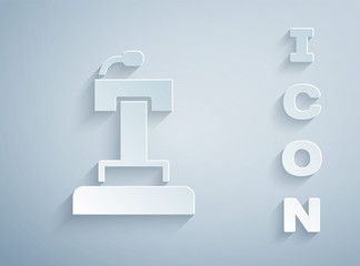 Paper cut Stage stand or debate podium rostrum icon isolated on grey background. Conference speech tribune. Paper art style. Vector.