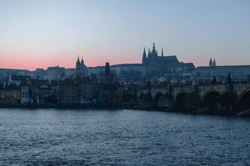 Sunset view of River Vltava, Charles Bridge and Prague Castle in Czech Republic
