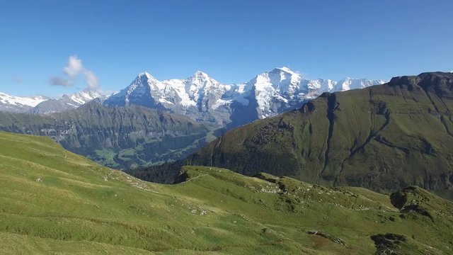 REVERSE AERIAL OF BEAUTIFUL SWISS MOUNTAINS AND TOURISTS ON RIDGE