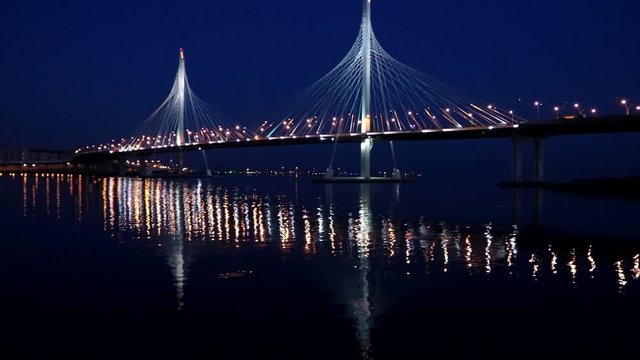 ZSD bridge at night . The car goes on the ZSD. The car goes over the bridge. Modern architecture. Toll road in Saint Petersburg.