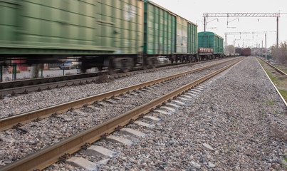 Obraz premium freight train moves fast during sunset.