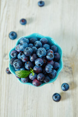 blueberries on a white wooden surface