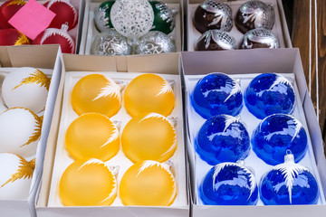 Set of Blue and Yellow Christmas Balls in a box. Christmas Decorations Sell on Market.