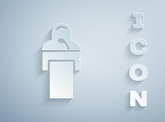 Paper cut Gives lecture icon isolated on grey background. Stand near podium. Speak into microphone. The speaker lectures and gestures. Paper art style. Vector.
