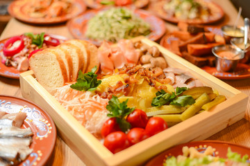 Covered table with traditional Ukrainian food, side view, horizontal. Traditional cuisine, birthday party, celebration.