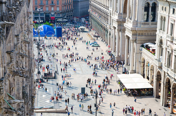 Crowd small figures of people on Piazza del Duomo square, Milan, Italy