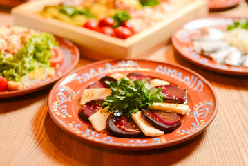 Covered table with traditional Ukrainian food, side view, horizontal. Traditional cuisine, birthday party, celebration.