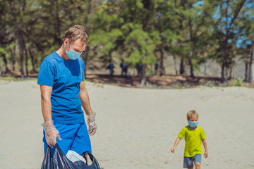 Volunteer blue face mask forest sand beach. Active father wait son help pick up garbage into black...