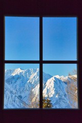view through window to snowy mountains, Alps, Austria