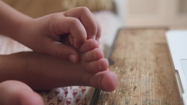 Close up shot of cute fingers, feet and toes of a five years old child