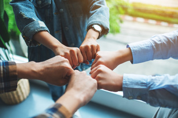 Group of business team work join their hands together with power and successful concept