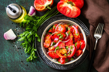 Summer Vegetable salad with fresh tomato, onion and olive oil. Healthy food. Top view flat lay.