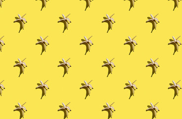 Trendy sunlight Summer pattern made with banana on bright light yellow background