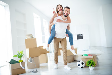 Full length body size view of nice attractive cheerful cheery couple piggy-backing showing v-sign...