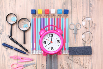 Back to school. Concept with stationery supplies for the school on wood background