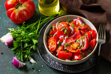 Summer Vegetable salad with fresh tomato, onion and olive oil. Healthy food.