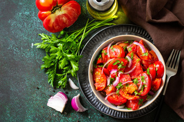 Summer Vegetable salad with fresh tomato, onion and olive oil. Healthy food. Copy space.