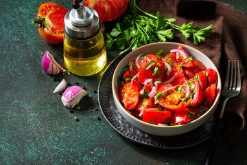 ummer Vegetable salad with fresh tomato, onion and olive oil. Healthy food. Copy space.