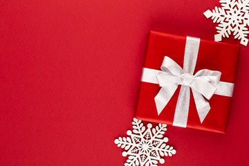 Christmas, holiday present box on red background.