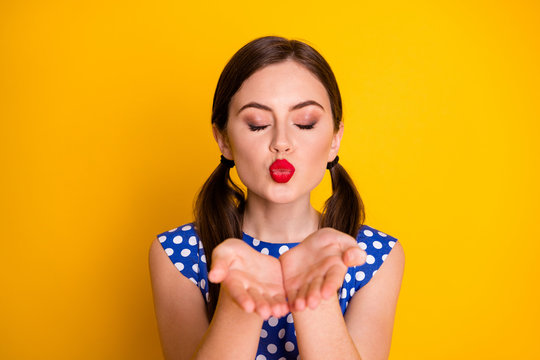 Close-up portrait of nice attractive lovely pretty sweet glamorous lovable girl wearing dotted sending air kiss date amour isolated over bright vivid shine vibrant yellow color background