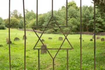 Star of David (symbol and sign of the Jews) on the iron grate of the old Jewish cemetery.