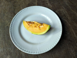 fresh healthy yellow fruit bite put in a white plate