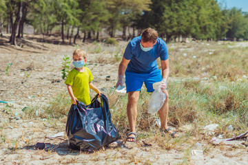 Volunteer blue face mask forest sand beach. Son helps father hold black bag for pick up garbage....