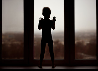 
child, window, child handles on the window, cloudy, sad