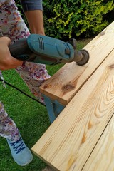 wood processing. emphasizing wood texture. woman working with wood outdoors. 