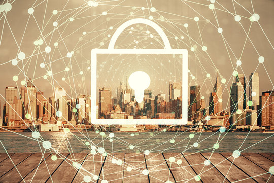 Lock icon hologram on city view with skyscrapers background multi exposure. Data security concept.
