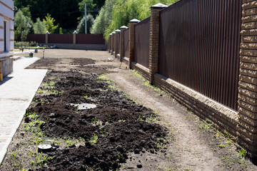 Soil preparation for sowing Lawn Herbs. Landscaping for leveling the site and rolling land for the Lawn.   