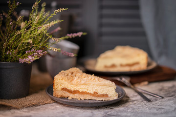 Rustic grated cottage cheese cake with caramel on grey table. Homemade crumb pie. Portion of  organic, healthy, country dessert. Copy space.