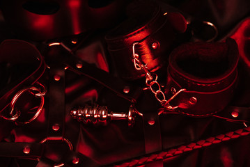 Set of accessories for BDSM sex with handcuffs, anal plug, Flogger