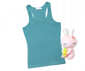 Turquoise tank top and stuffed toy on a white background