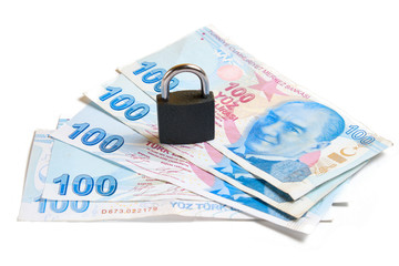 Padlock on hundred turkish lira bills isolated on white